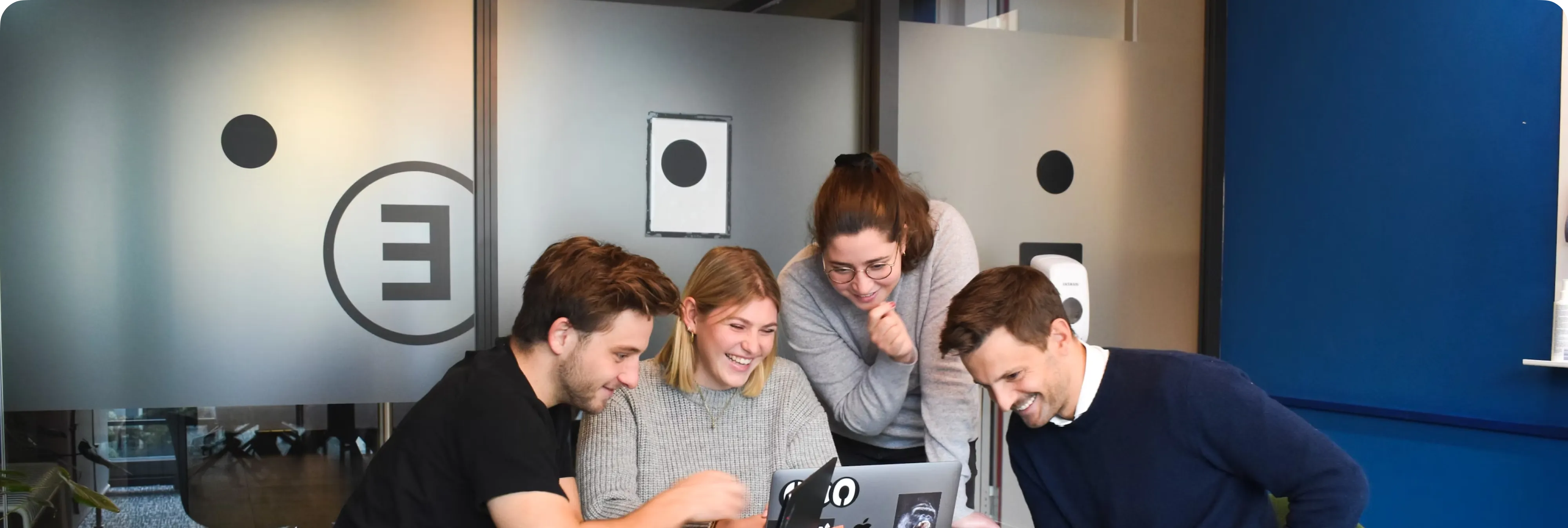 The TrustDesk team collaborating in a bright modern office